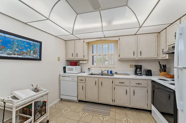 a kitchen with a sink dishwasher and cabinets