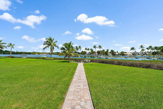 a view of building with swimming pool and green space