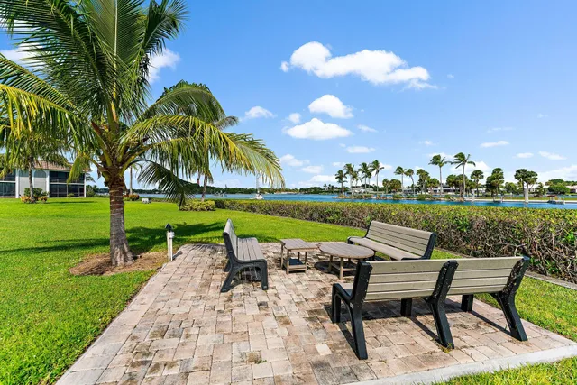 a swimming pool with outdoor seating and yard