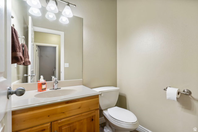 557 South 1470th Street East Springville, UT 84663 - Photo 22 of 46 Half bathroom with toilet and vanity
