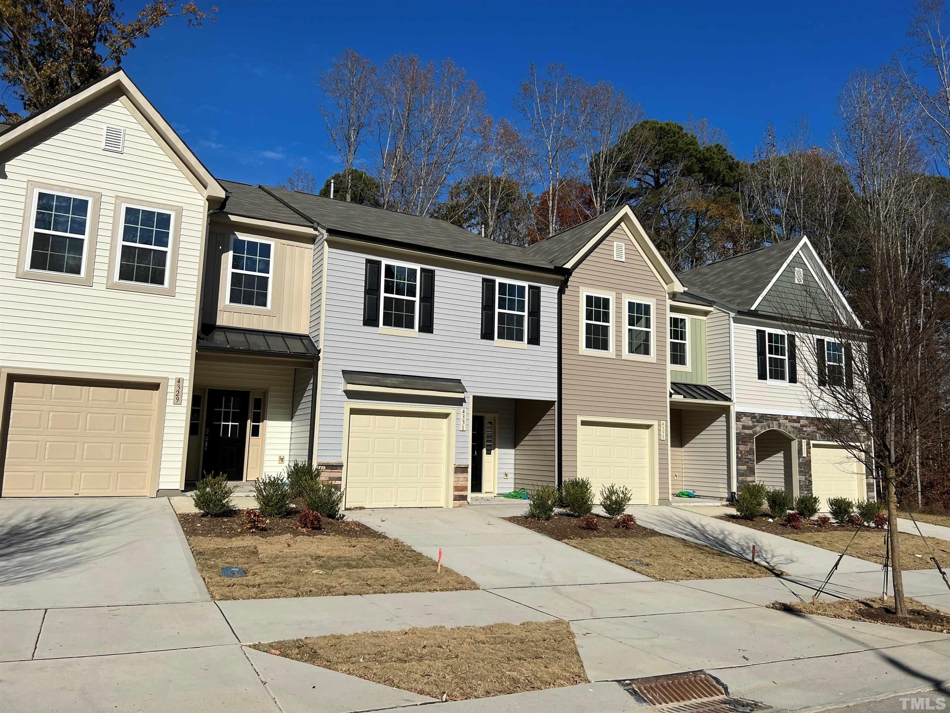 4733 Lord Fogelman Way Raleigh, NC 27610 - Photo 29 of 29 a front view of a house with a yard and garage