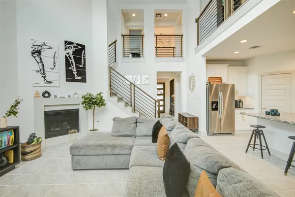 a living room with furniture a fireplace and a large window