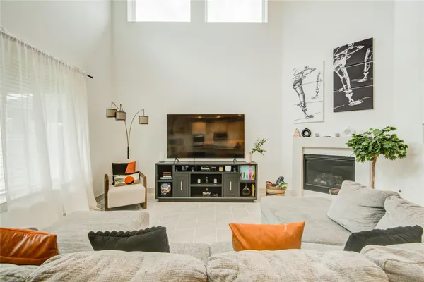 a living room with fireplace furniture and a flat screen tv