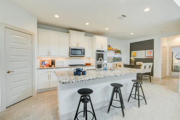 a large kitchen with granite countertop a sink and counter space