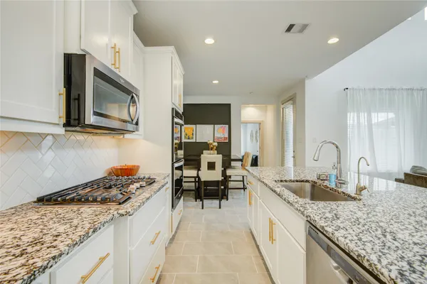 a kitchen with granite countertop cabinets and a stove
