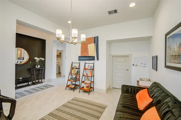 a bedroom with furniture and a chandelier