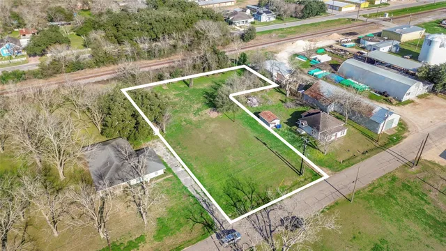 a view of a backyard with wooden floor and seating space