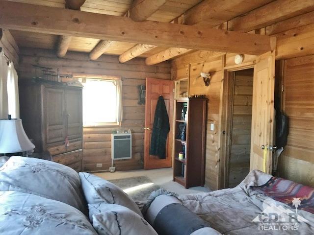 35155 Tool Box Spring Road Mountain Center, CA 92561 - Photo 11 of 27 a bedroom with a bed and wooden floor