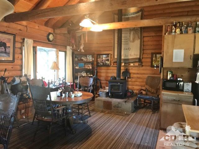 35155 Tool Box Spring Road Mountain Center, CA 92561 - Photo 5 of 27 a view of a dining room with furniture window and wooden floor
