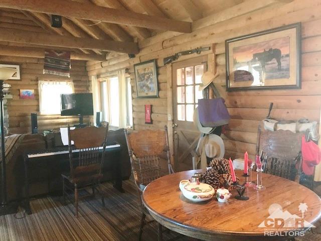 35155 Tool Box Spring Road Mountain Center, CA 92561 - Photo 6 of 27 a dining room with furniture a kitchen wooden floor and a chandelier