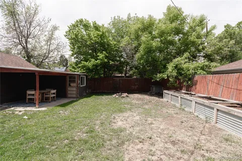 a backyard of a house with table and chairs