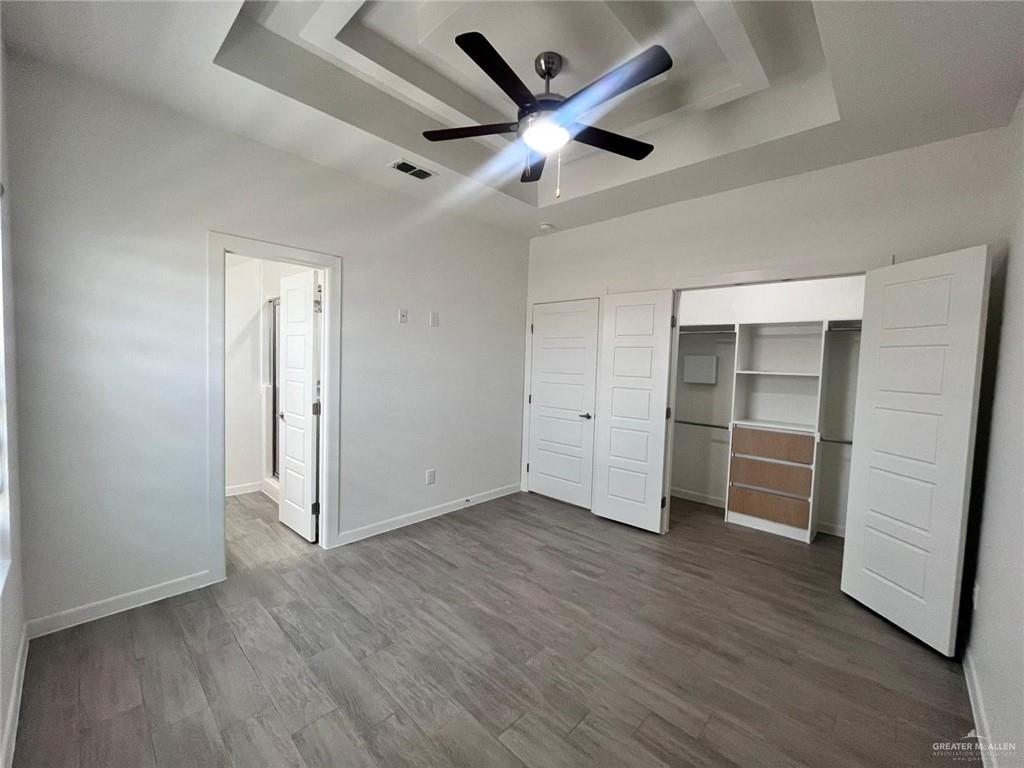 3900 Ventura Avenue, Unit 3 Edinburg, TX 78541 - Photo 7 of 14 an empty room with wooden floor and a ceiling fan