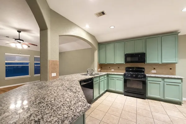 a kitchen with stainless steel appliances granite countertop a stove and a sink