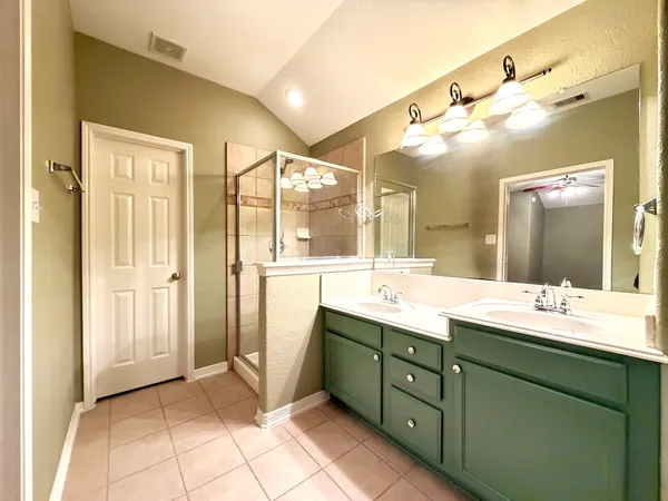 a spacious bathroom with a double vanity sink mirror and