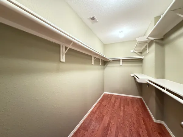 a view of a room with wooden floor and staircase
