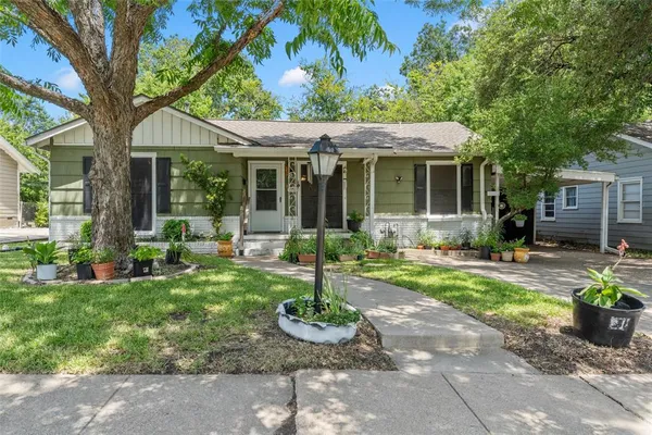 a view of a house with backyard sitting area and garden