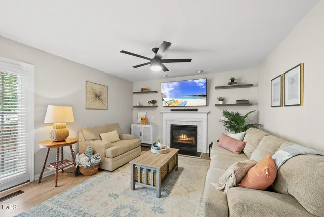 a living room with furniture a fireplace and a window