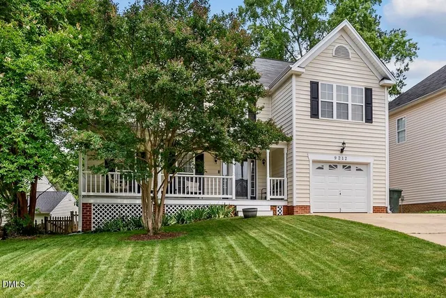a house that has a tree in front of it