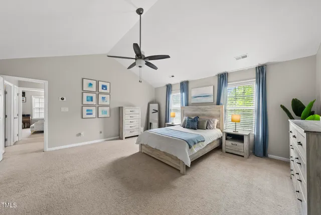 a spacious bedroom with a bed and a chandelier
