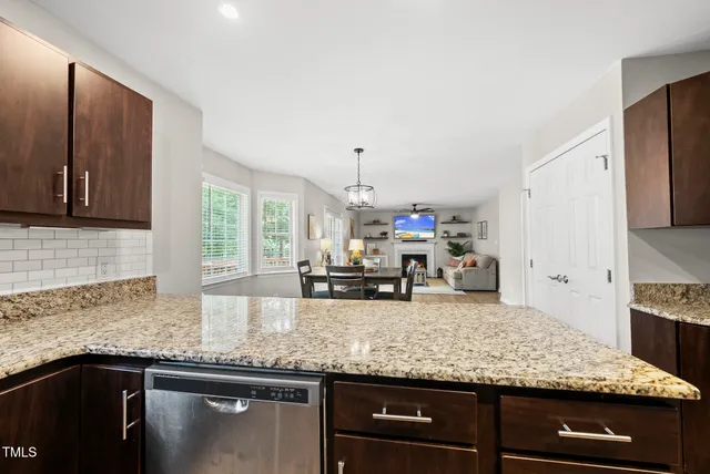 a kitchen with granite countertop stainless steel appliances and sink