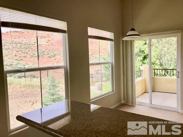 9050 Double R Boulevard, Unit 1125 Reno, NV 89511 - Photo 11 of 24 a living room with hardwood floor and large windows