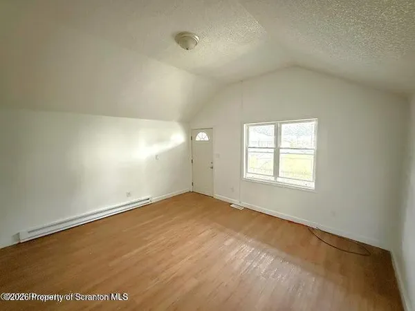 an empty room with a empty space and windows