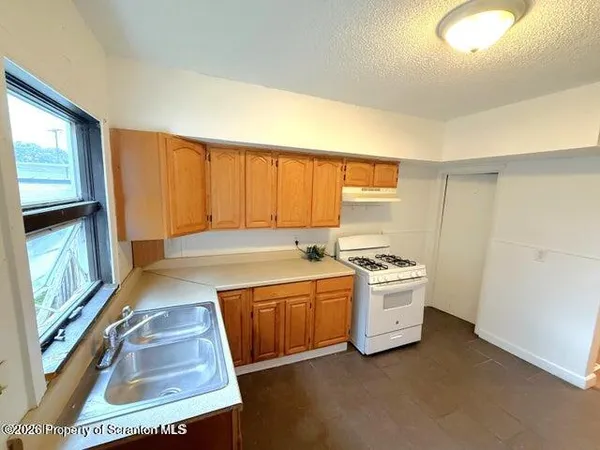 a kitchen with a stove and a sink