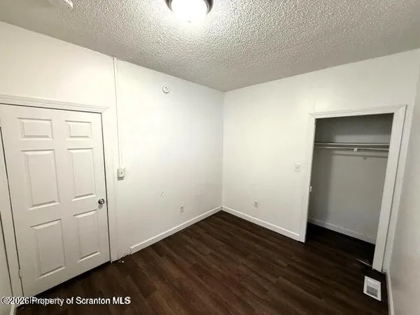 an empty room with wooden floor