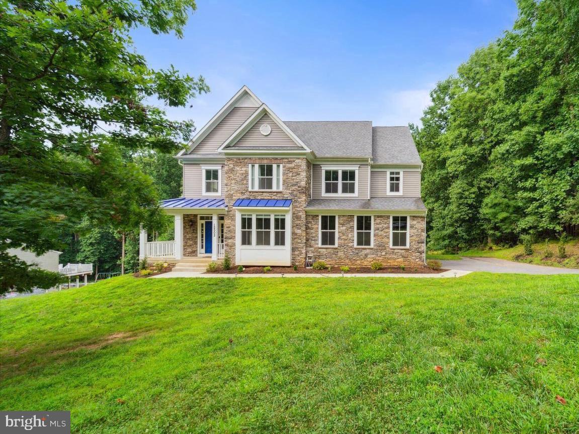 Charming stone home in lush greenery.