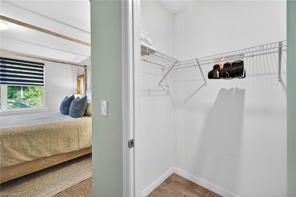 14567 Edgewater Circle Naples, FL 34114 - Photo 21 of 43 a bedroom with a bed and a window