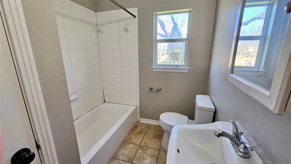 a bathroom with a tub and a window