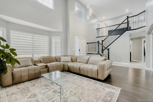 a living room with furniture and stairs