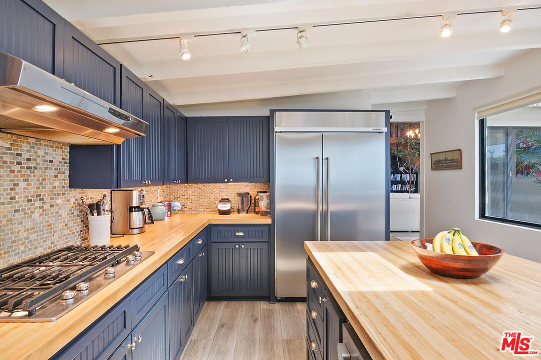 107 Malibu Colony Road Malibu, CA 90265 - Photo 4 of 12 a kitchen with a sink and refrigerator