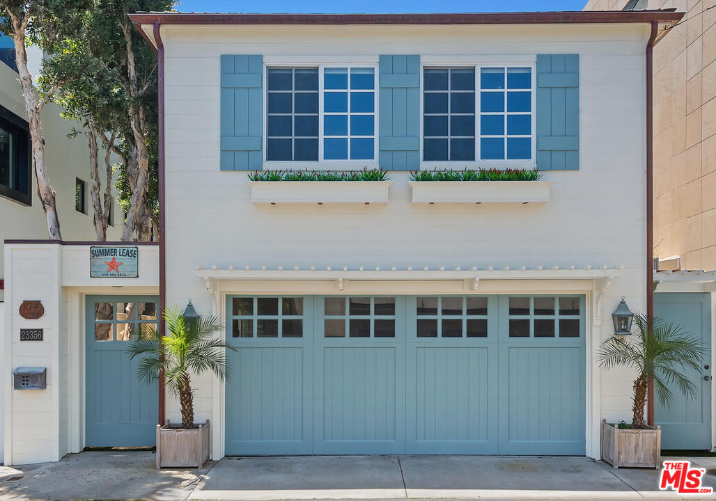 107 Malibu Colony Road Malibu, CA 90265 - Photo 10 of 12 a front view of a building with a garden