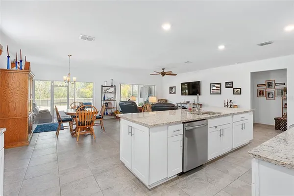 a kitchen with sink and white cabinets
