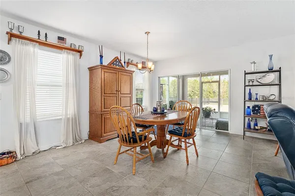 a view of a dining room with furniture and a chandelier