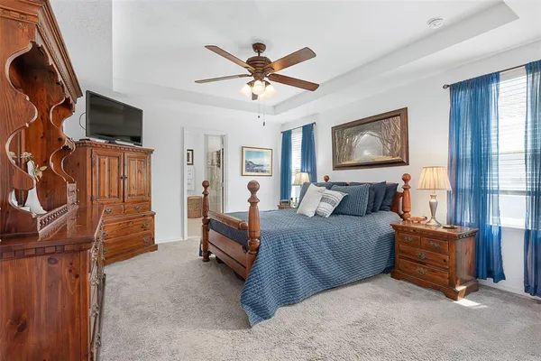 a living room with furniture a flat screen tv and a window