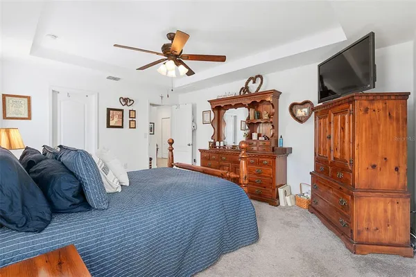 a bedroom with a bed and flat screen tv