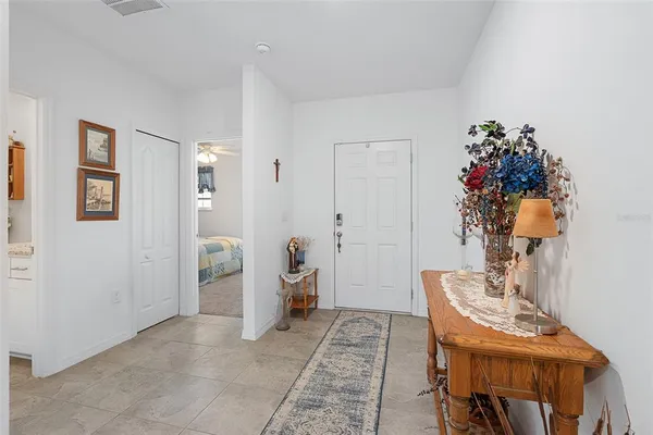 a living room with furniture and a dining table