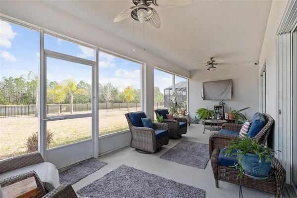 a living room with furniture and a floor to ceiling window