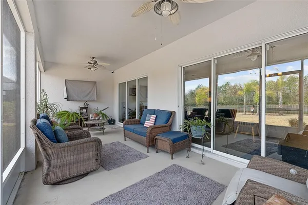 a living room with furniture and a floor to ceiling window