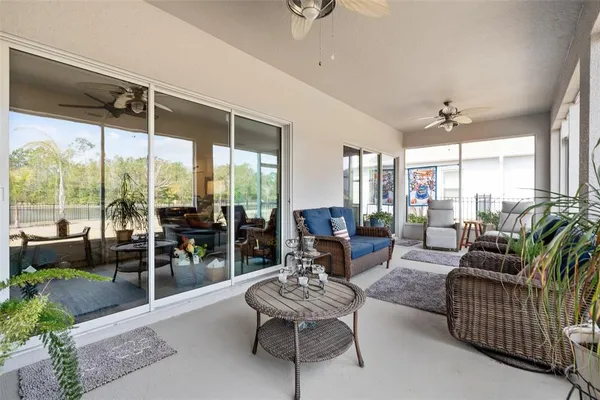 a living room with furniture and a floor to ceiling window