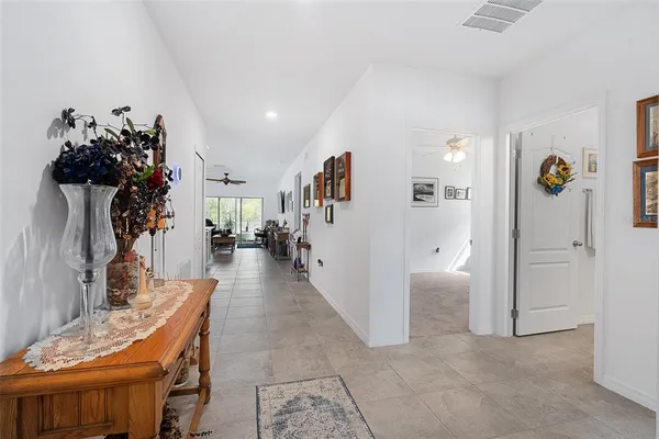 a view of a hallway to a livingroom with furniture