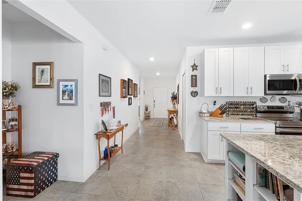 a kitchen with stainless steel appliances granite countertop a refrigerator and a stove top oven