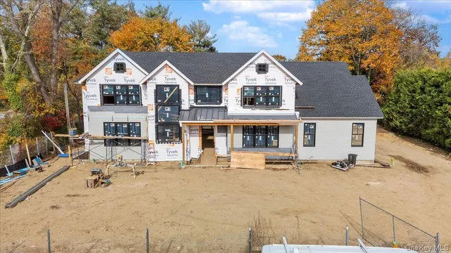 a view of a house with wooden fence