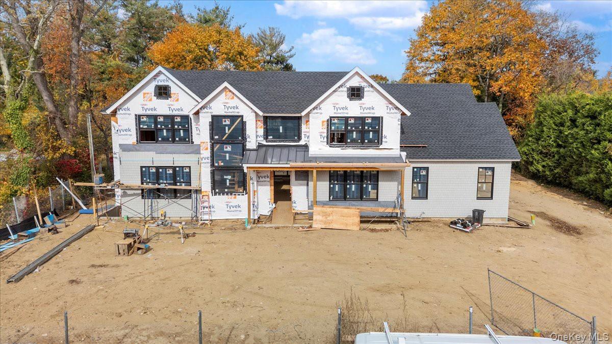 97 Crabapple Road Manhasset, NY 11030 - Photo 4 of 8 a view of a house with wooden fence