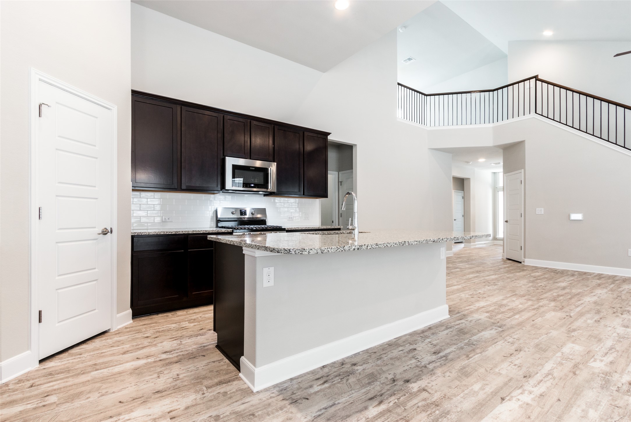 9301 Alex Lane Austin, TX 78748 - Photo 10 of 40 a kitchen with granite countertop a refrigerator and a stove top oven