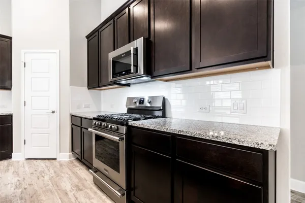 a kitchen with a refrigerator and a microwave