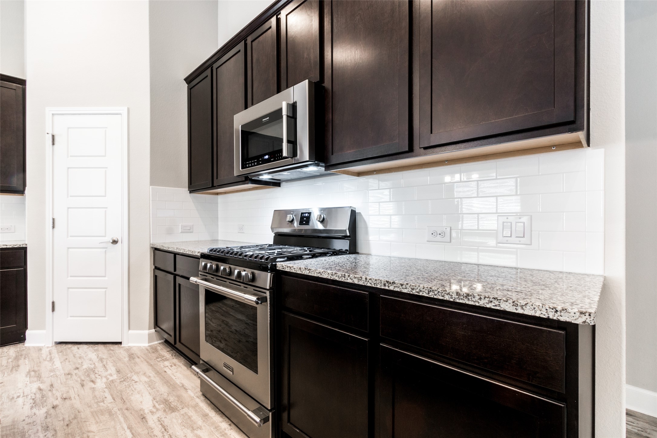 9301 Alex Lane Austin, TX 78748 - Photo 13 of 40 a kitchen with stainless steel appliances granite countertop a stove microwave and sink