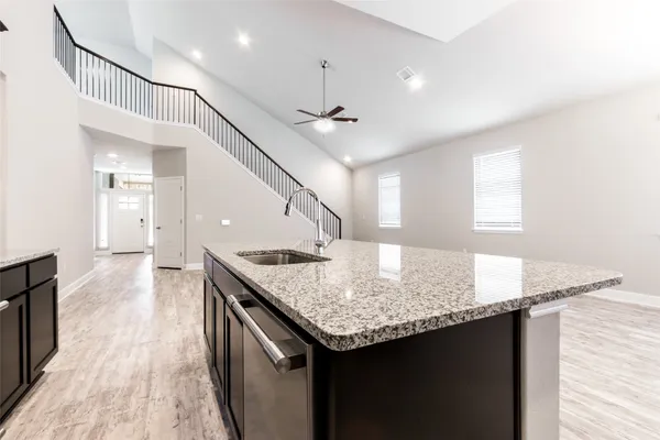 a kitchen with stainless steel appliances granite countertop a sink stove and microwave
